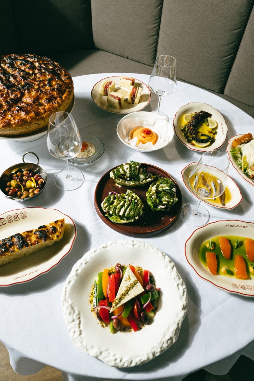 A generous Marmo table set with Mediterranean dishes